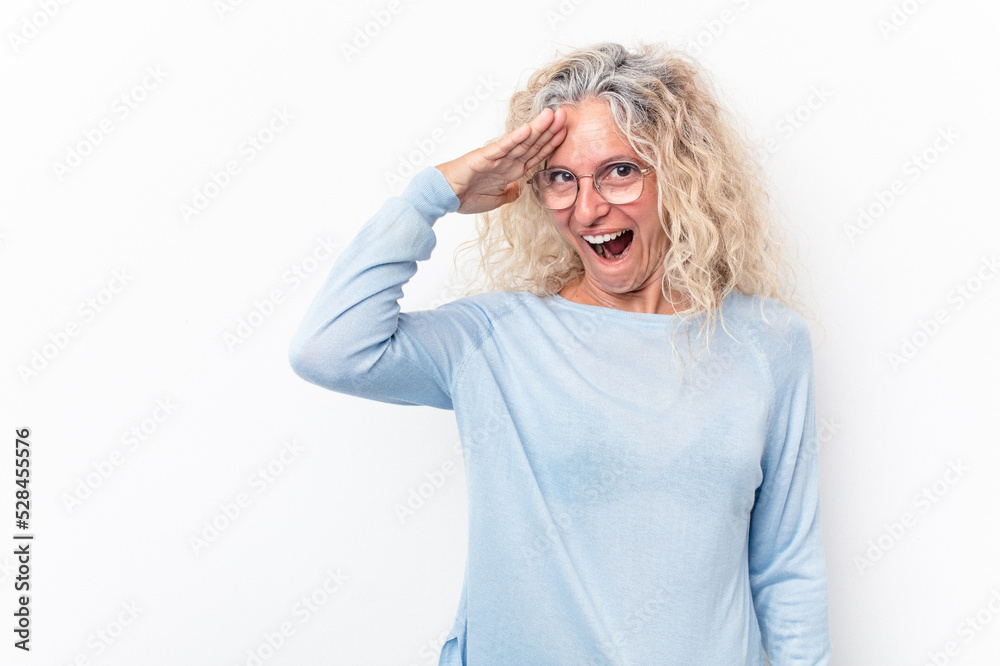 Middle age caucasian woman isolated on white background shouts loud, keeps eyes opened and hands tense.