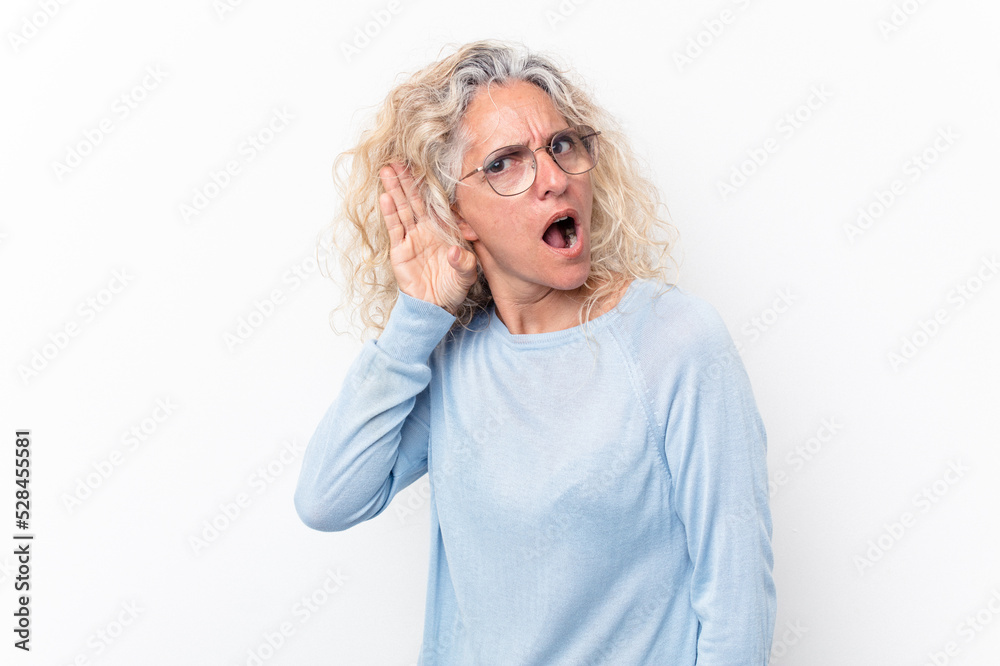 Middle age caucasian woman isolated on white background trying to listening a gossip. Middle age caucasian woman isolated on white background trying to listening a gossip.