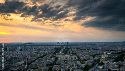 Aerial panoramic view of Paris skyline with Eiffel Tower, Les Invalides and business district of Defense at sunset, as seen from Montparnasse Tower, Paris, France