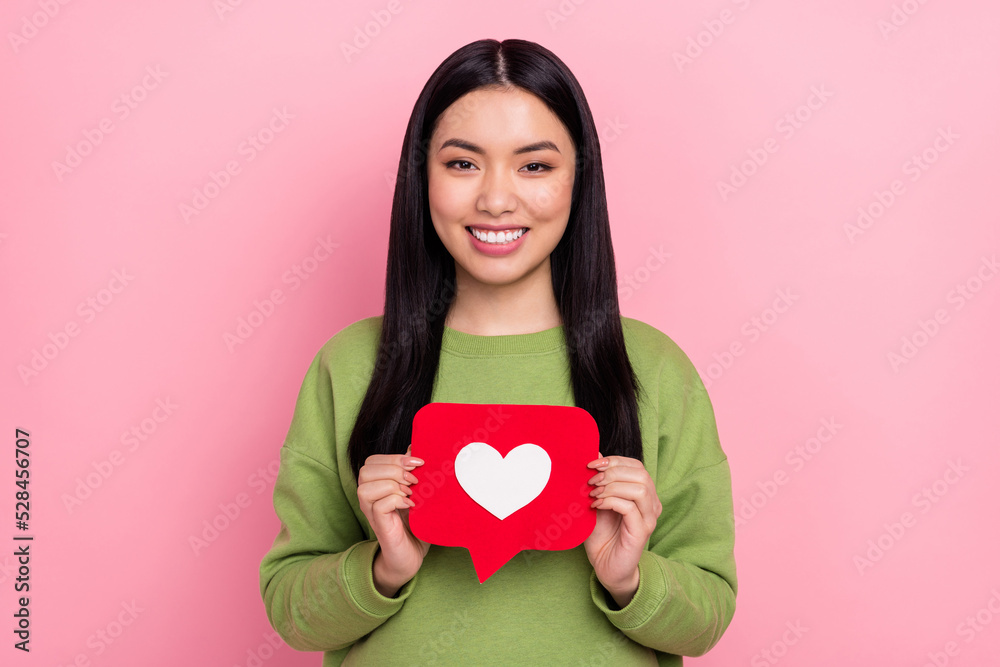 Photo of sweet young lady hold like wear green jumper isolated on pink color background Photo of sweet young lady hold like wear green jumper isolated on pink color background