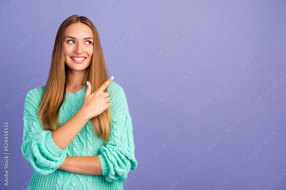 Portrait of positive charming person look indicate finger empty space proposition isolated on purple color background Portrait of positive charming person look indicate finger empty space proposition isolated on purple color background