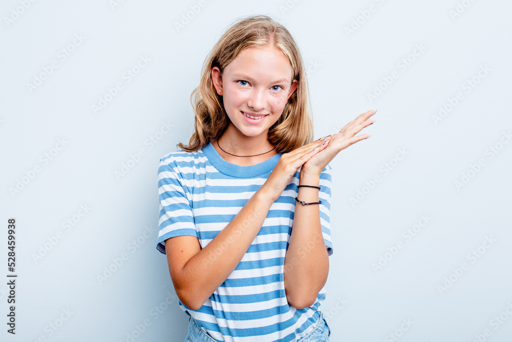 Caucasian teen girl isolated on blue background feeling energetic and comfortable, rubbing hands confident.