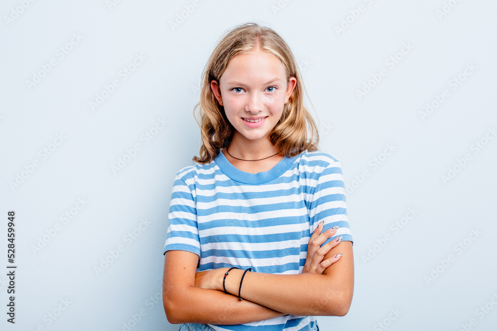 Caucasian teen girl isolated on blue background who feels confident, crossing arms with determination. Caucasian teen girl isolated on blue background who feels confident, crossing arms with determination.