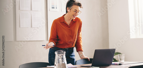 Happy businesswoman pitching her idea to a client in an online meeting photo