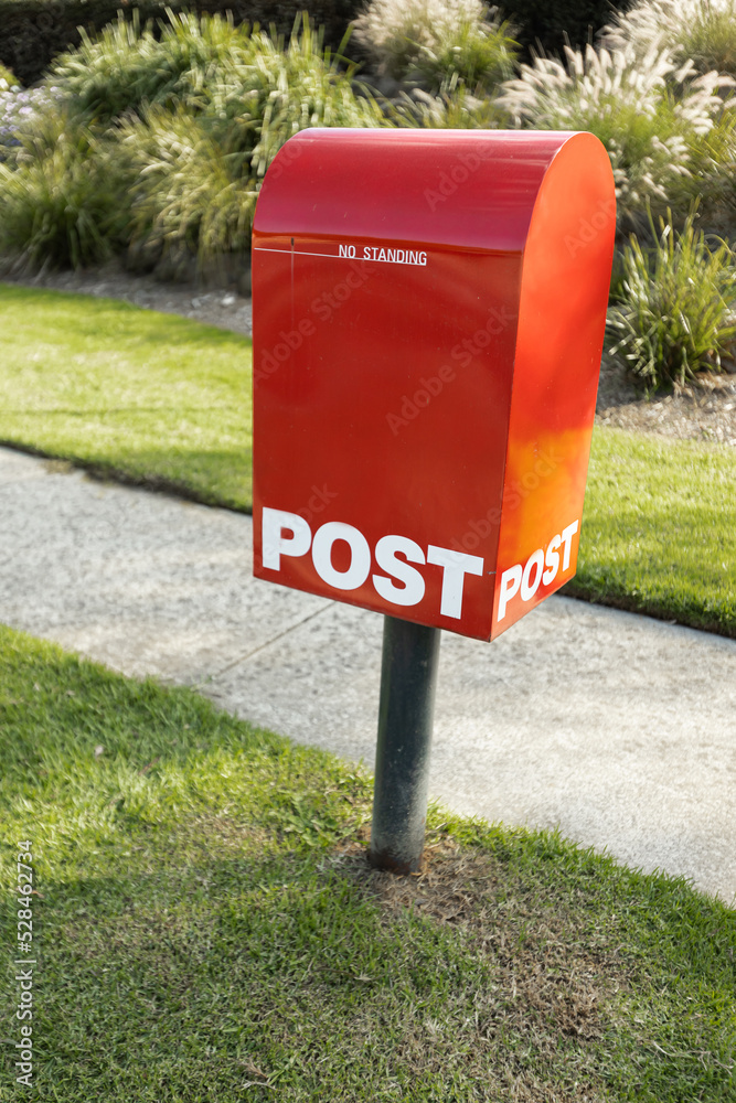 A red australia post letter box stripped of all branding and logos. A red australia post letter box stripped of all branding and logos.