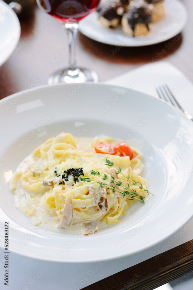 Traditional italian pasta with mushrooms in a restaurant Traditional italian pasta with mushrooms in a restaurant