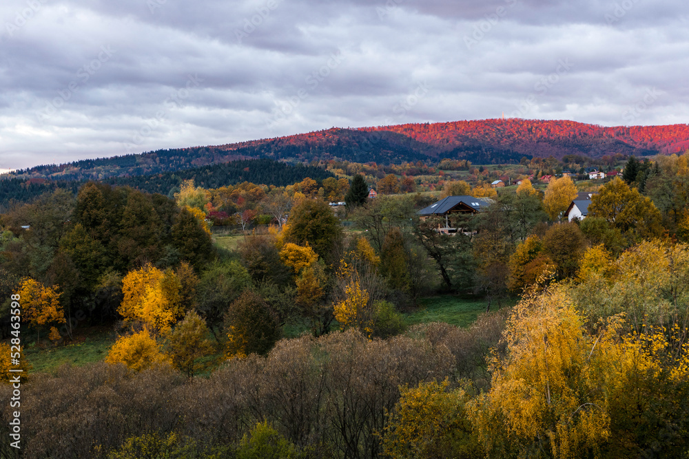 Red mountain highlighted by the sun in the mountains. Sunrise on autumn in Beskid Niski. 