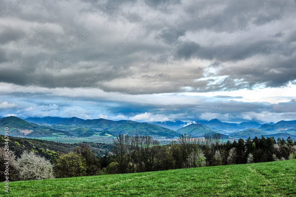 Beautiful hilly landscape with grey cloudy sky. View of the valley. Vrsatec, Slovakia