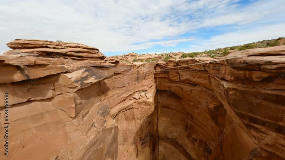 Rising Through Soaring Sandstone Canyon Cliff With A Bungee Cord