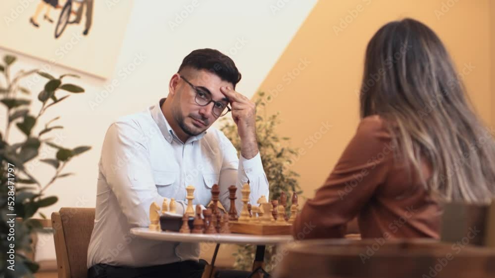Man and woman thinking on tactical strategy of next move on chessboard during sport competitions in chess.Young couple in love playing in favourite game in free time Man and woman thinking on tactical strategy of next move on chessboard during sport competitions in chess.Young couple in love playing in favourite game in free time