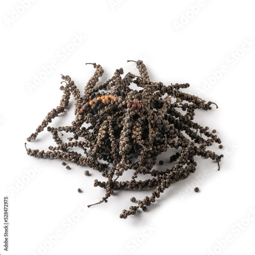 pile of dried black peppercorns, dry black pepper fruits or drupes isolated on white background, spicy and seasoning ingredient photo