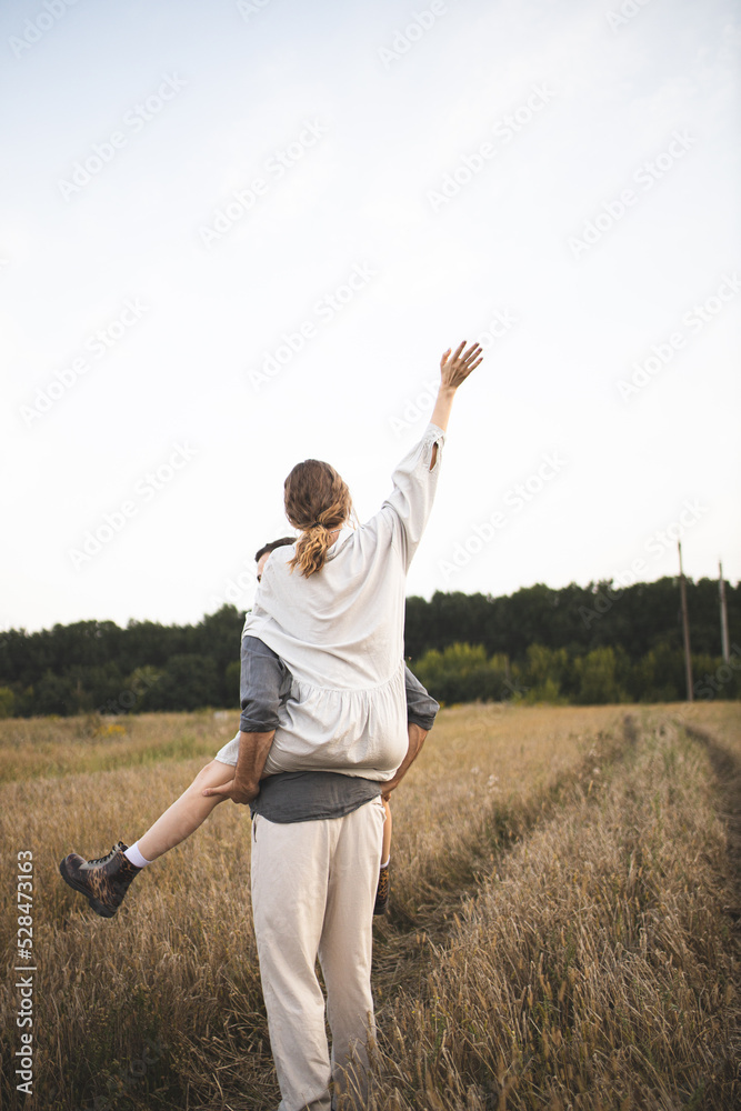 Loving couple of man and woman in the field. A couple in love is walking in the field and enjoying life. Romance and love. Happy and romantic couple. Love between two people. Loving couple of man and woman in the field. A couple in love is walking in the field and enjoying life. Romance and love. Happy and romantic couple. Love between two people.