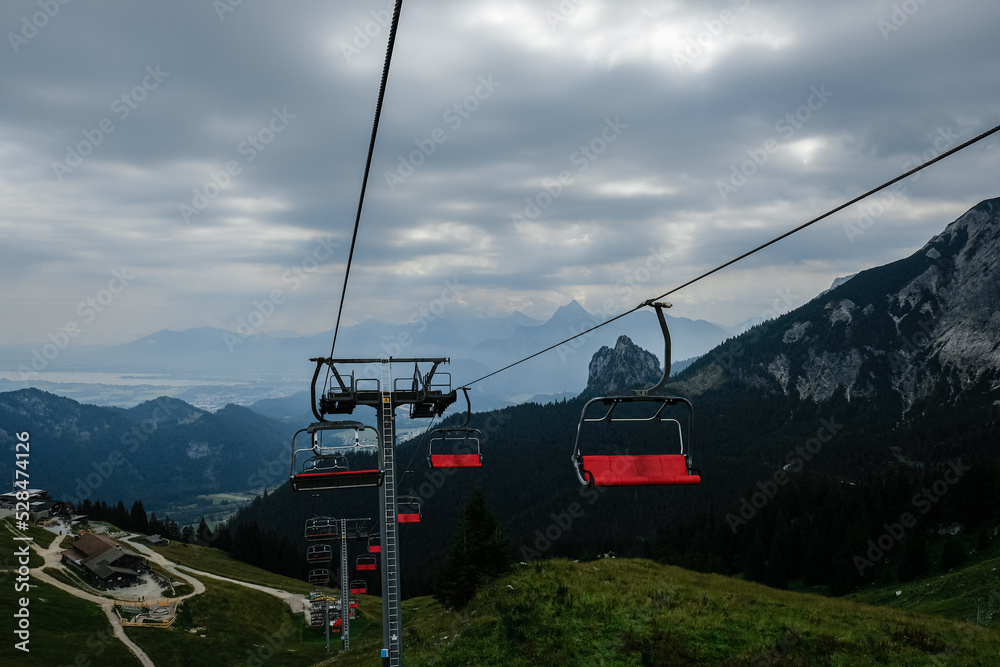 Red mountain chair lift with cloudy bavarian alps in Steinach, Pfronten Allgäu