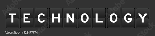 Black color analog flip board with word technology on gray background