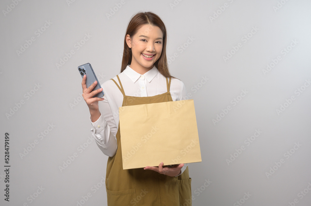 Portrait of young asian woman wearing apron over white background studio, cooking and entrepreneur concept Portrait of young asian woman wearing apron over white background studio, cooking and entrepreneur concept