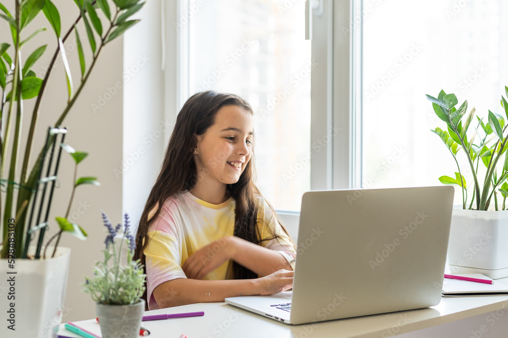 Excited Teen Girl Sitting In Living Room With Laptop, During Webinar At Home. Online School Tests Concept Excited Teen Girl Sitting In Living Room With Laptop, During Webinar At Home. Online School Tests Concept