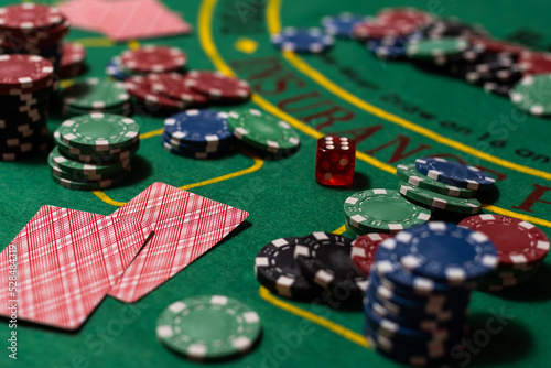 Poker cloth, a deck of cards, poker hand and chips. Background