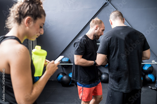 Athletic sportive friends indoor gym chatting together