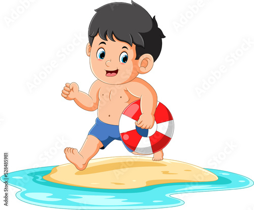 The cute boy is running and holding the tire to swim on the beach