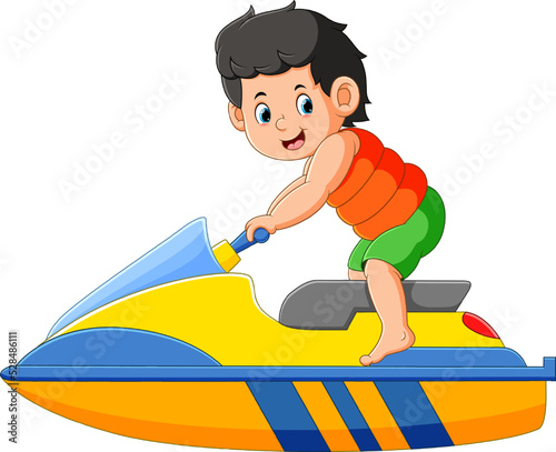 The happy boy is playing and riding on the jet ski on the beach