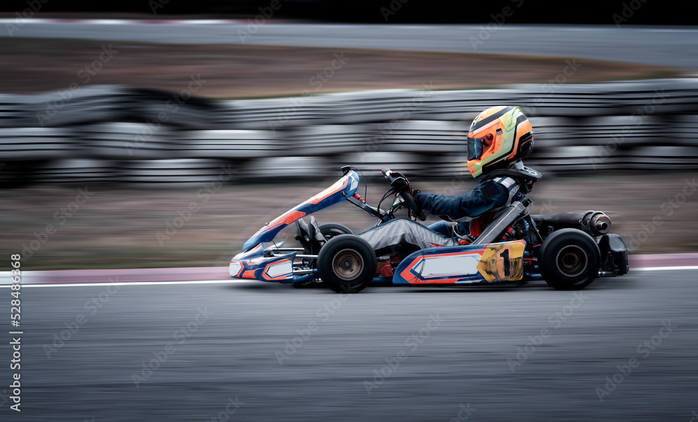 Go kart racing field, racer wearing safety uniform on competition tournament.	 - obrazy, fototapety, plakaty 