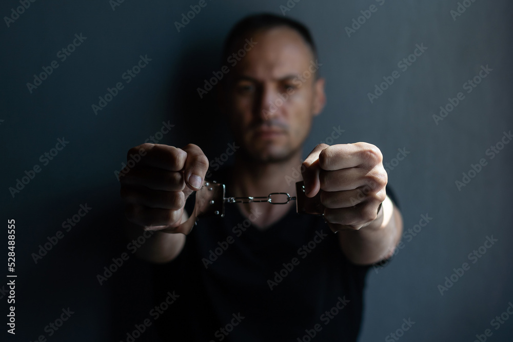 prisoner concept, Handcuffed hands of a prisoner in prison, Male prisoners were severely strained in the dark prison, violence, prisoner concept, Handcuffed hands of a prisoner in prison, Male prisoners were severely strained in the dark prison, violence,