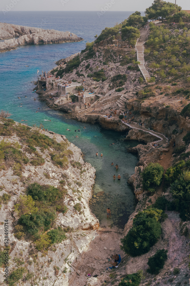 People swimming in a cove in Mediterranean Sea Holiday People swimming in a cove in Mediterranean Sea Holiday