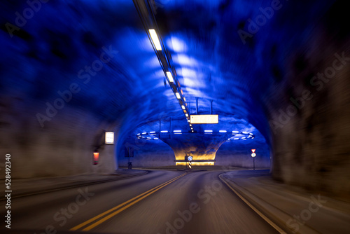 Roundabout in a tunnel in Norway, lighted in blue photo
