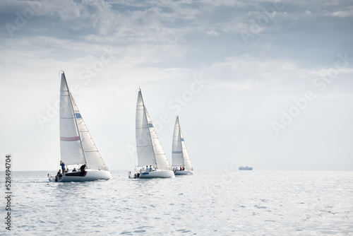 Group of yachts sailing in the wind during regatta