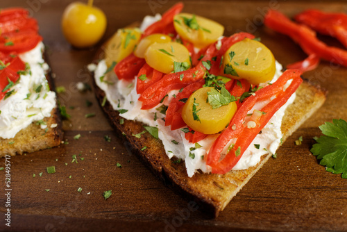 Healthy toast with pointed peppers and siberian crab apple on cream cheese and feta cheese.