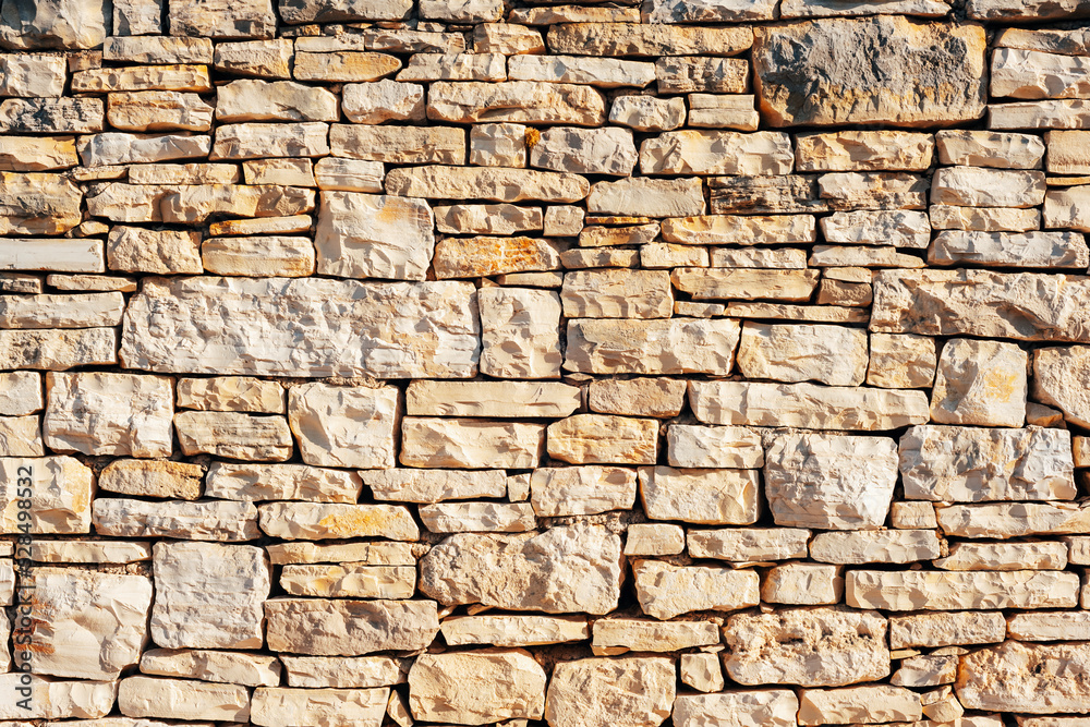 Old beige grunge stone masonry background, texture