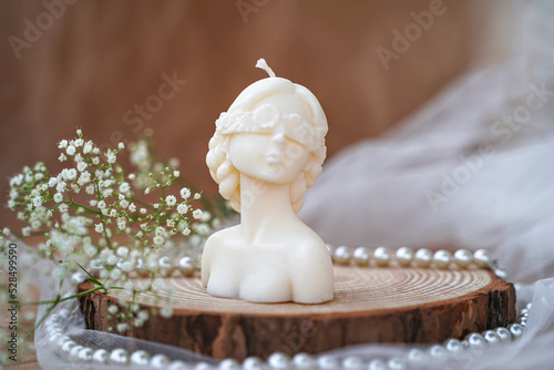Decorative candle in form of woman bust. Soy candle handmade. Concept of femininity
