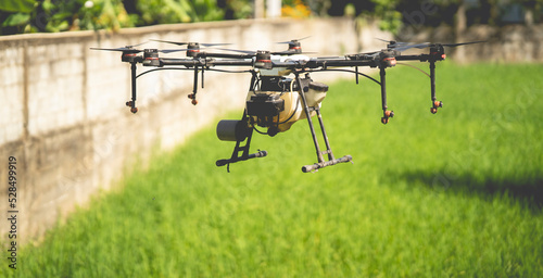 Agriculture drone fly to sprayed fertilizer on the fields, Agriculture drone flying and spraying fertilizer and pesticide over farmland,High technology innovations and smart farming