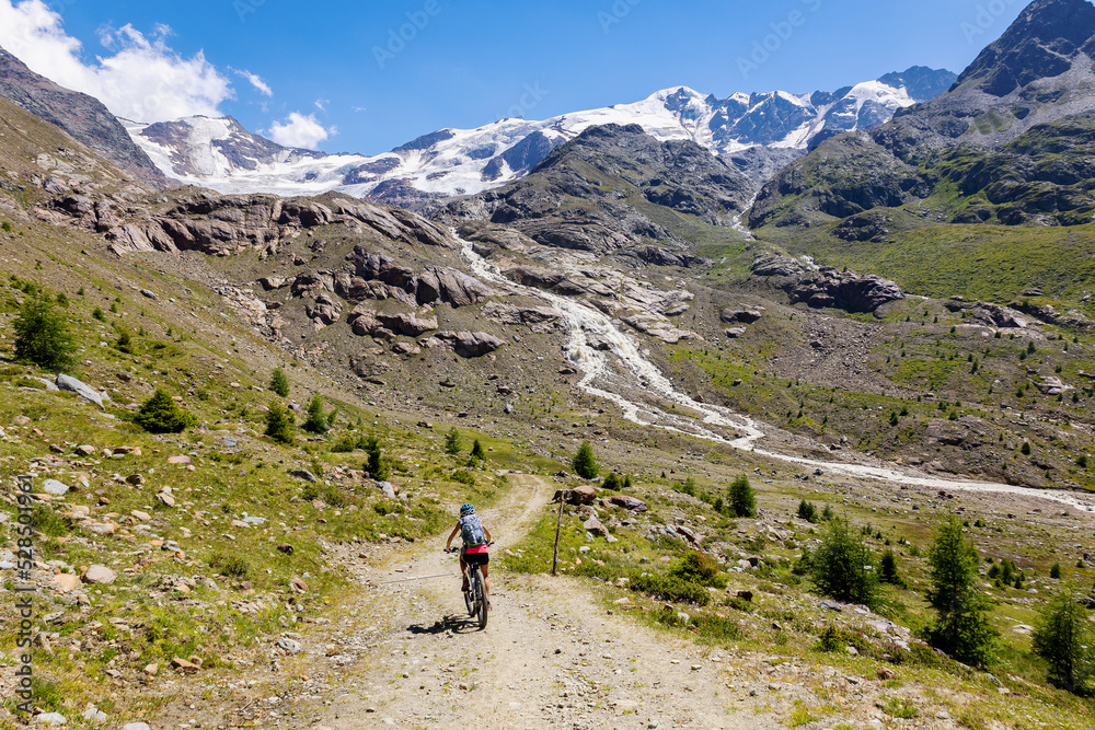 MTB excursion in the valley of Forni in the Stelvio National Park, in the background the Forni glacier, July 2022