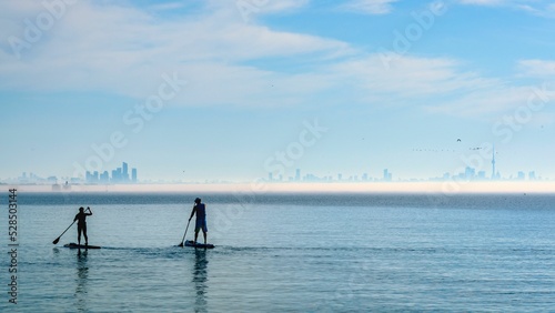 Canvastavla Persons paddling on boards on sea