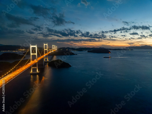 Light from sunset lingers over Seto Inland Sea and Kurushima suspension bridge at night