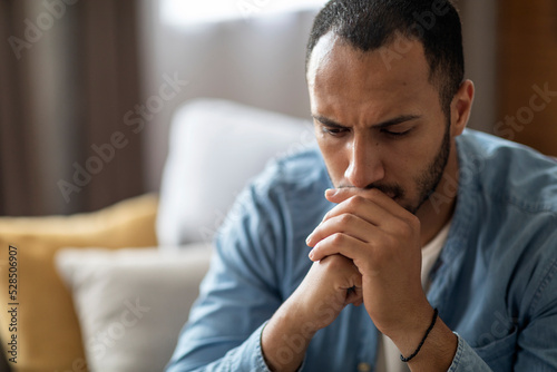 Closeup Portrait Of Thoughtful Young Black Man At Home Interior, photo