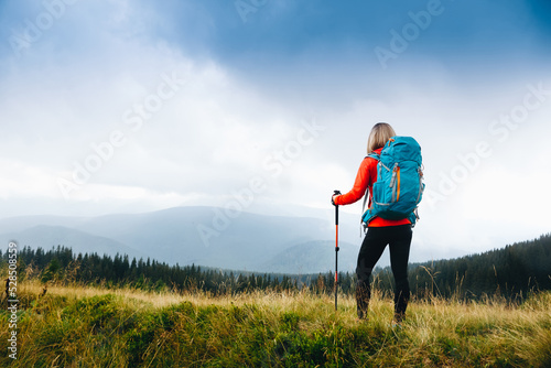 Hiker Young Woman With Backpack in the Mountain Top. Discovery Travel Destination Concept