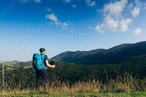 Man traveling with backpack hiking in mountains Travel Lifestyle success concept adventure active vacations outdoor mountaineering sport © olyphotostories