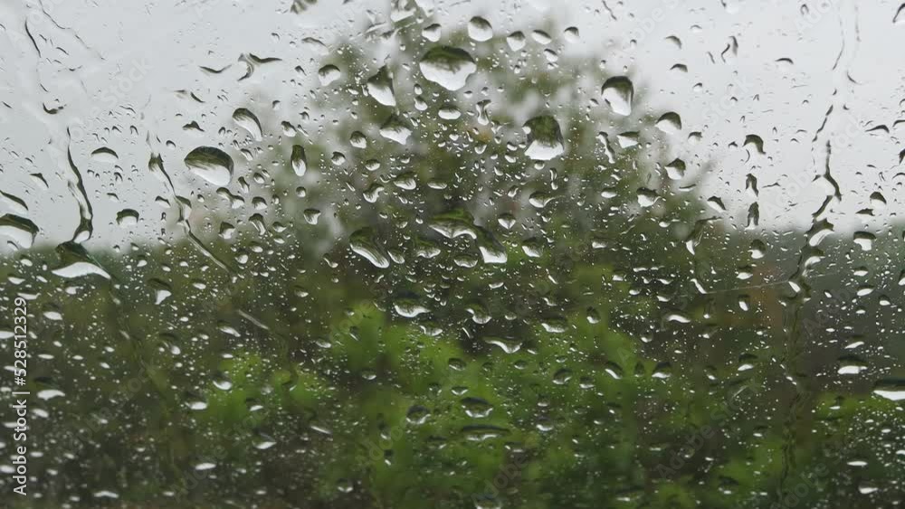 Raindrops on glass on a cloudy rainy day