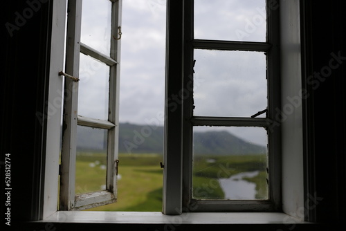 open window overlooking the mountains and meadows of iceland