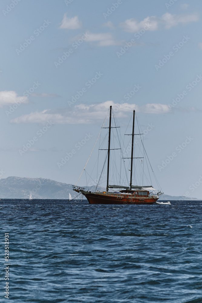 Fototapeta premium view of wooden ship in the coast of cagliari shoreline - poetto beach.