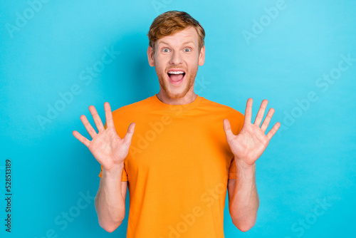 Portrait of funky guy show two arm demonstrates shock see low prices black friday sale isolated on aquamarine color background