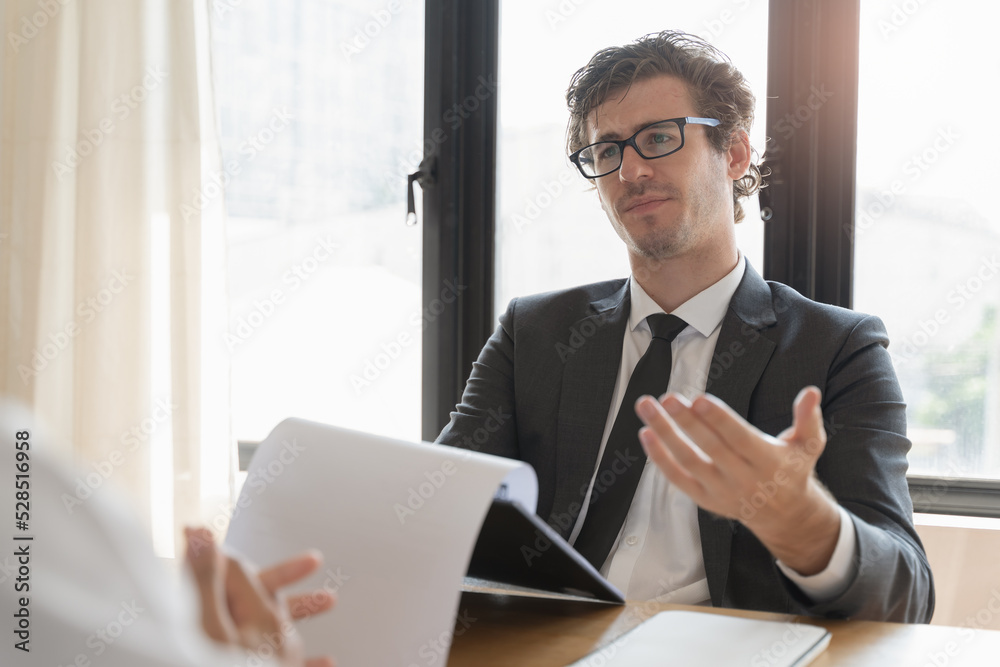 interviewer on the table asking question applicant in the office. interviewer on the table asking question applicant in the office.