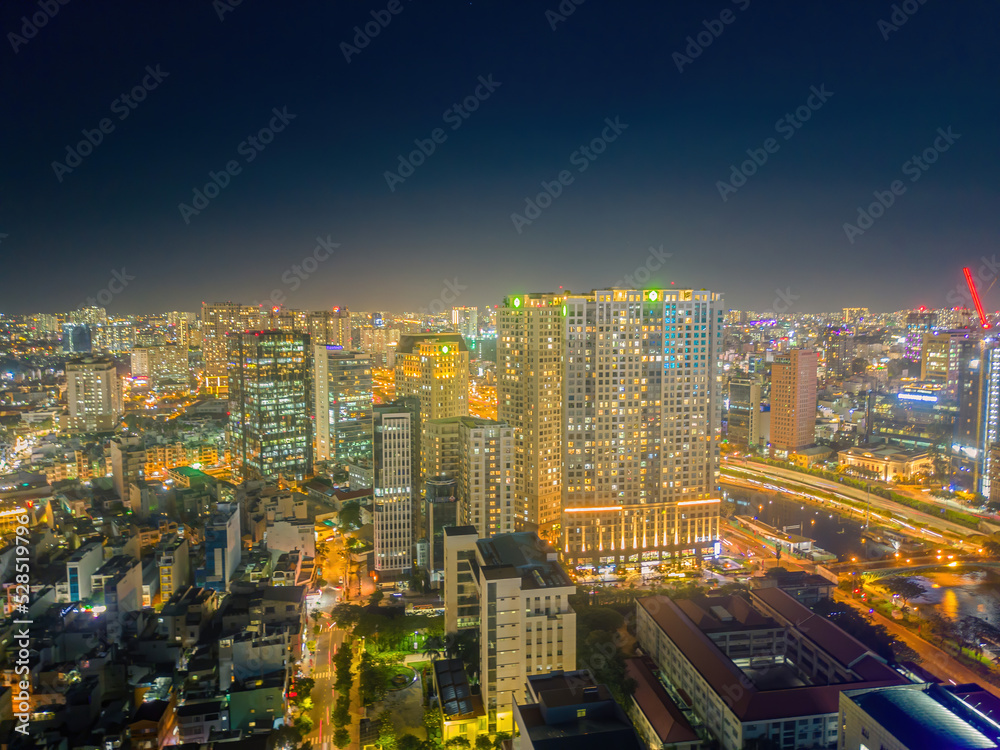 Aerial panoramic cityscape view of Ho Chi Minh city and Saigon river, Vietnam. Center of heart business at downtown with buildings and towers.