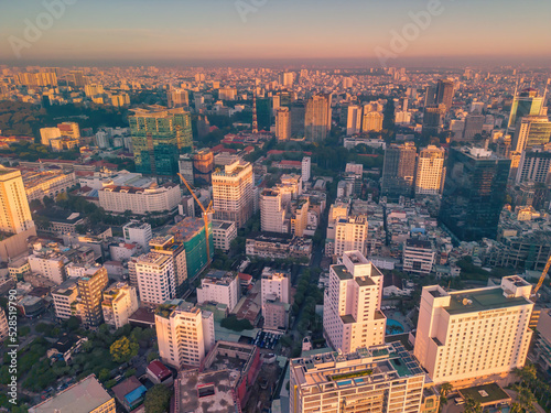 Aerial panoramic cityscape view of Ho Chi Minh city and Saigon river, Vietnam. Center of heart business at downtown with buildings and towers.