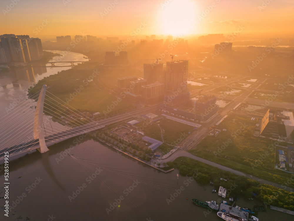 Fototapeta premium Aerial view of Ho Chi Minh City skyline and skyscrapers on Saigon river, center of heart business at downtown. Morning view. Far away is Landmark 81 skyscraper