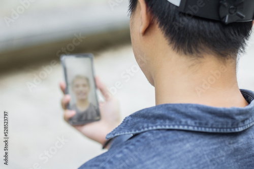 Man Having Video Call With Friends Via Mobile Phone