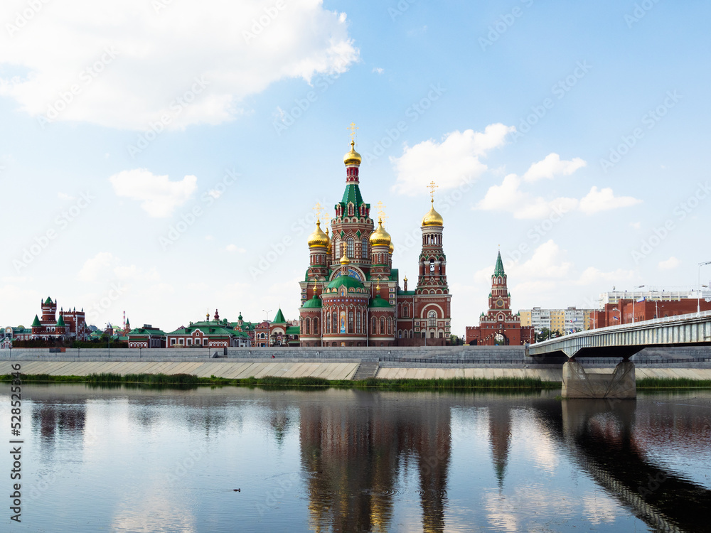 view of Cathedral of the Annunciation of the Blessed Virgin Mary near Theater bridge across Malaya Kokshaga river in Yoshkar-ola city on summer day
