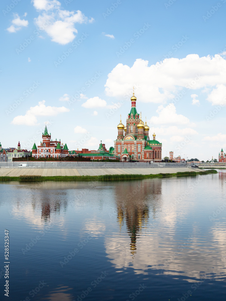 Cathedral of the Annunciation of the Blessed Virgin Mary on waterfront of Malaya Kokshaga river in Yoshkar-ola city on sunny summer day